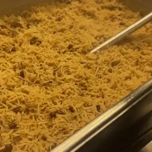 A serving of classic Caribbean rice and peas, seasoned to perfection, and served as a side dish to complement any meal.